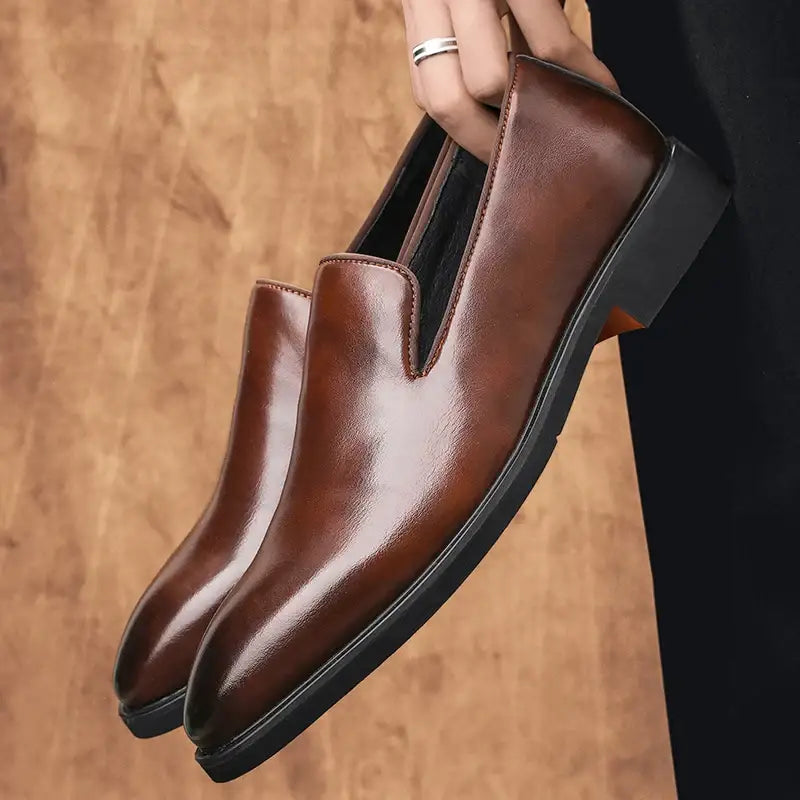 Polished brown leather Balcor rugan erkek slip-on dress shoe held by a hand