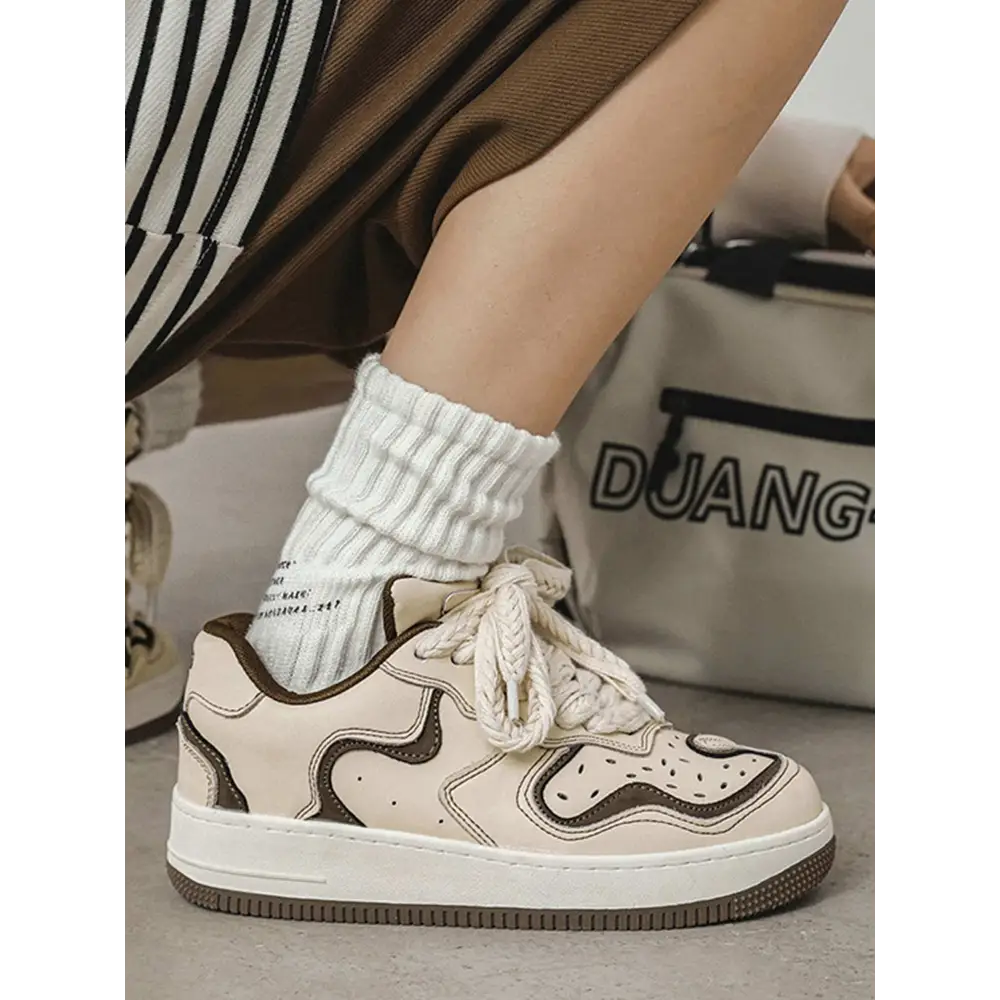 Janor unisex sneakers featuring a white and brown design with a chunky sole