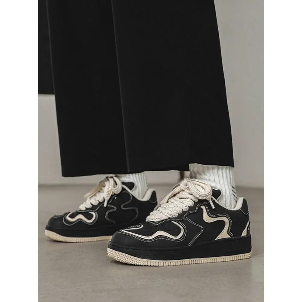 Janor unisex sneakers in black and white with wavy stripes and white socks