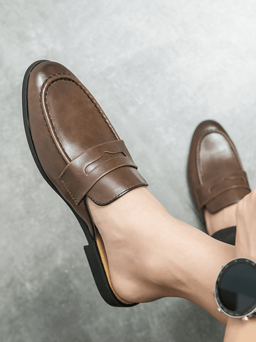 Brown leather Jorlen erkek terlik worn on a foot, showcasing elegant style