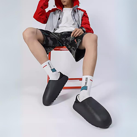 Cerlinor unisex sandalet featuring oversized black slip-on shoes with a red and white outfit