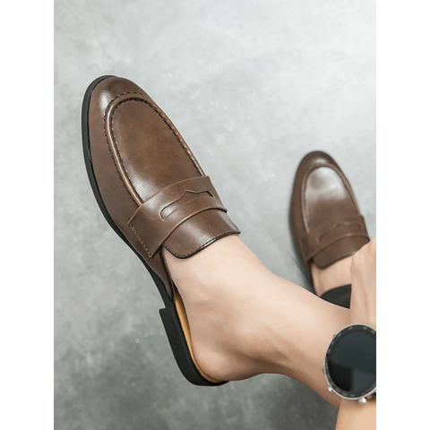 Brown leather Jorlen erkek terlik worn on a foot, showcasing elegant style