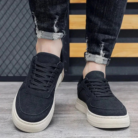 Velrinor unisex sneakers in black with white soles styled with distressed jeans